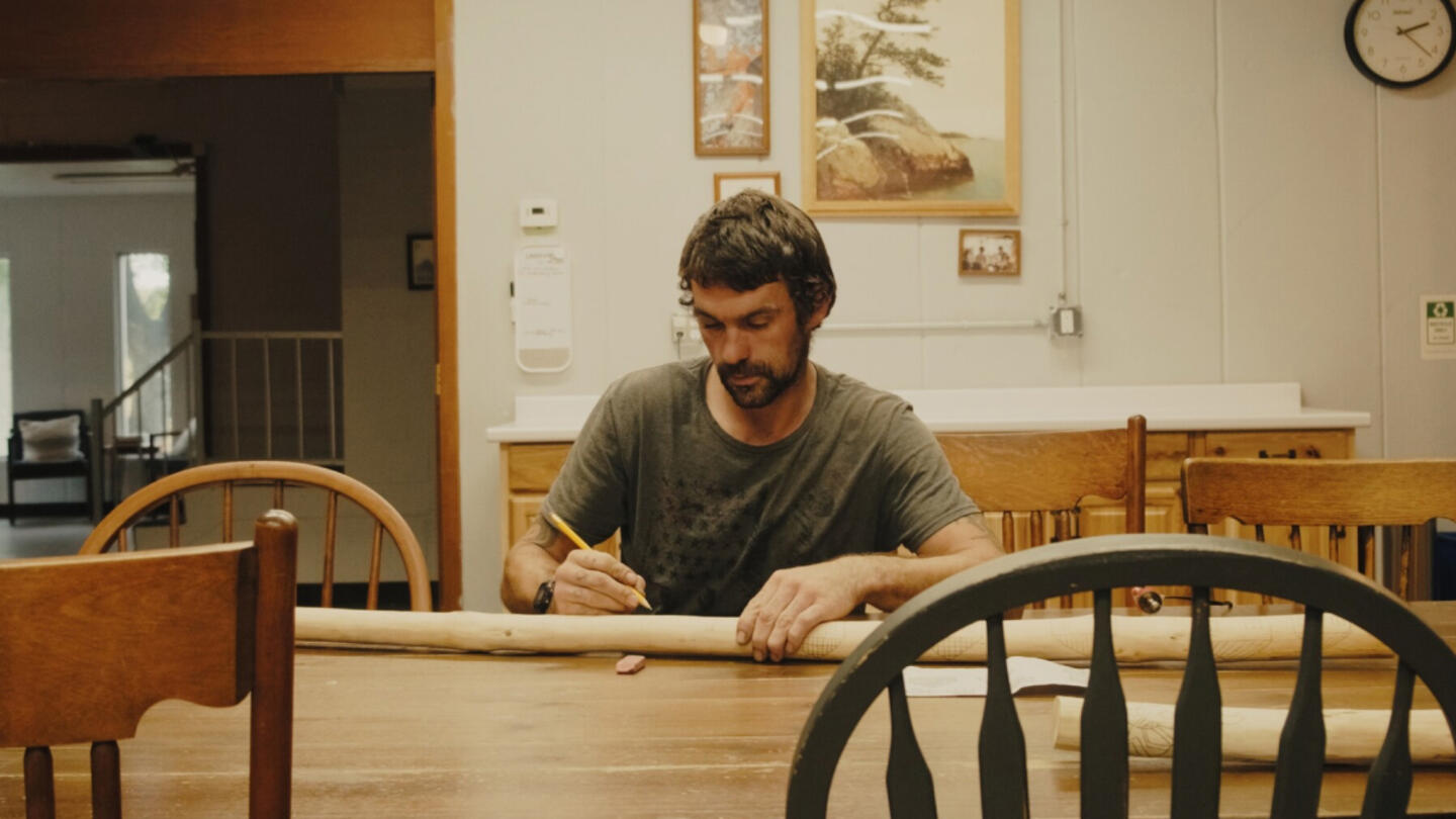 Man sitting at a kitchen table.