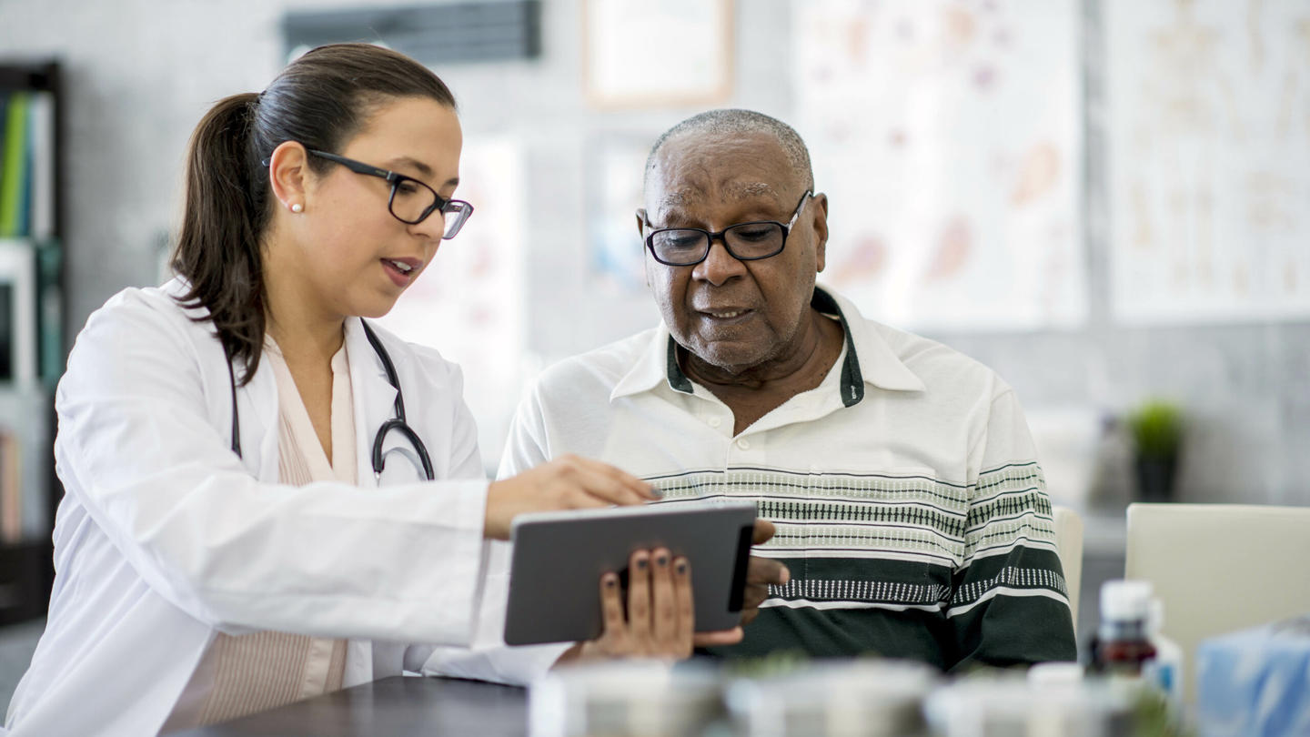 A doctor speaking with an older man