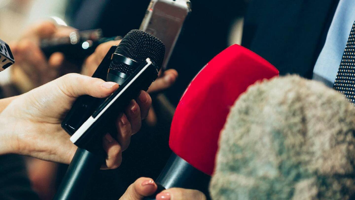 Reporters recording a person talking