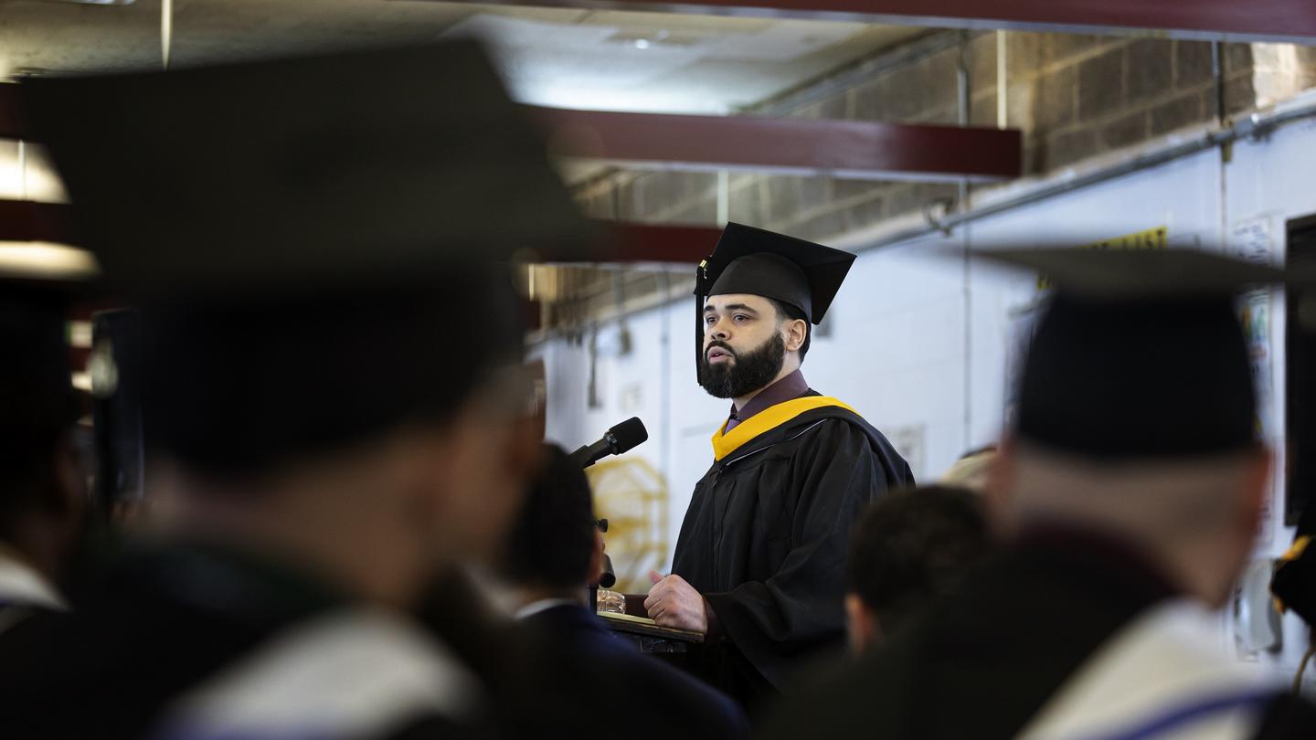 A man giving a speech at a graduation