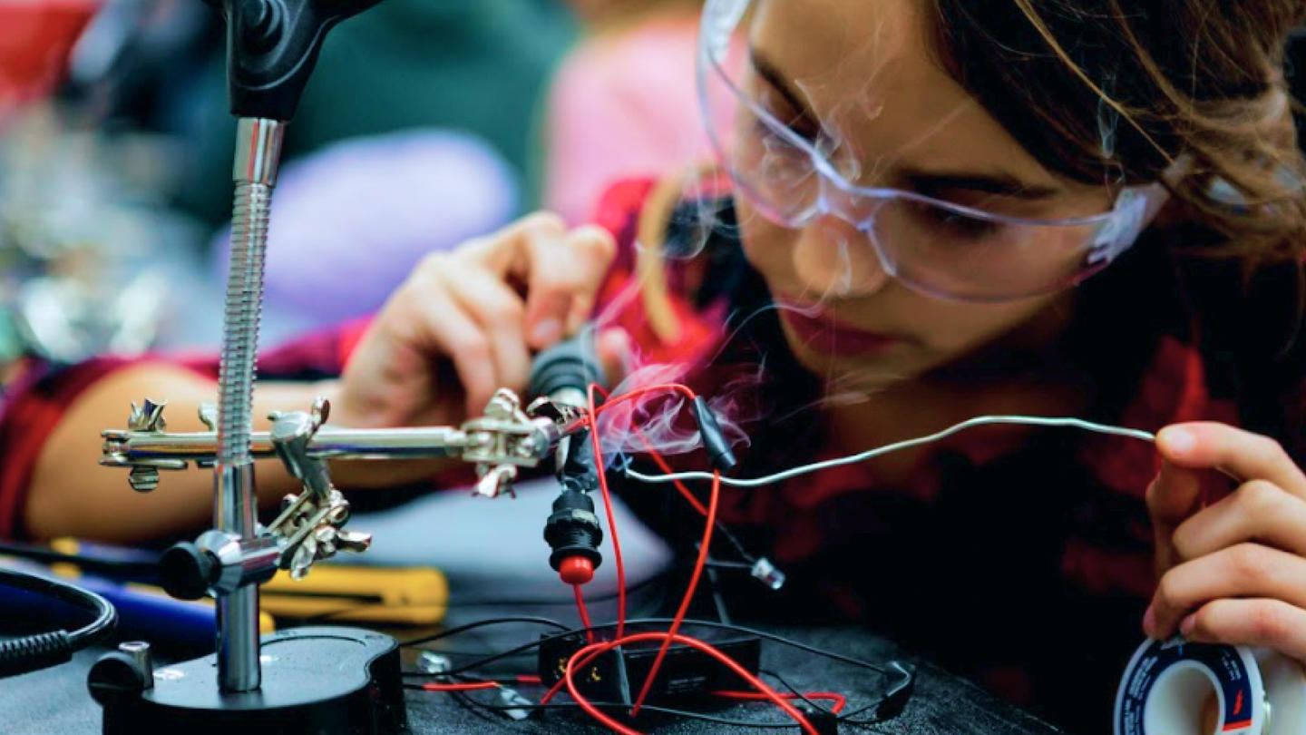 Student soldering wires