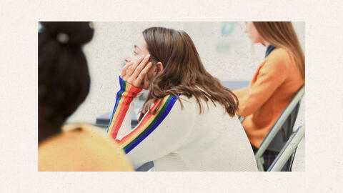 A girl in a classroom focusing on the lesson.