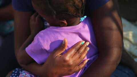 Mother holding her child.