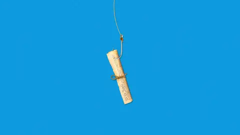 A fishhook catches a rolled copy of the U.S. Constitution against a bright blue background.