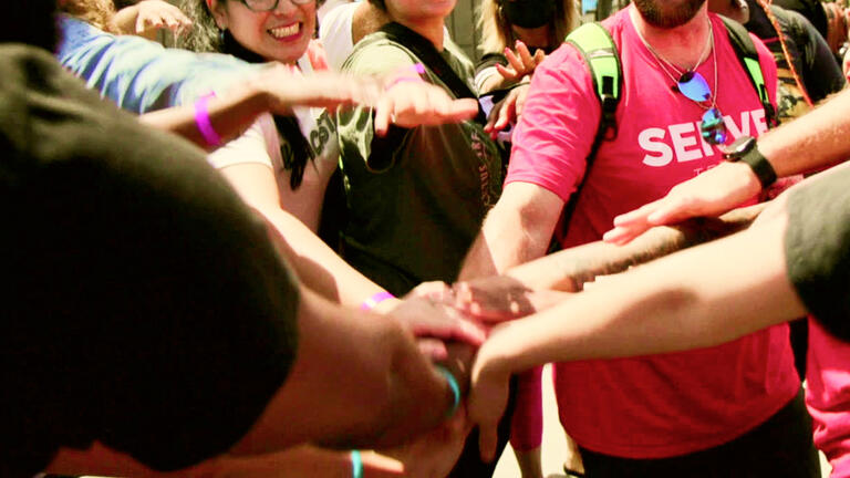 A group of people huddling together.