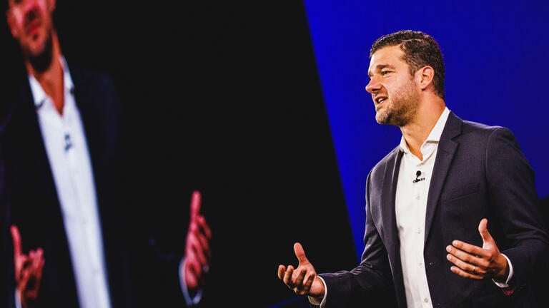 Sal Churi, founder of Trust Ventures, speaks on stage at a conference of business leaders and philanthropists
