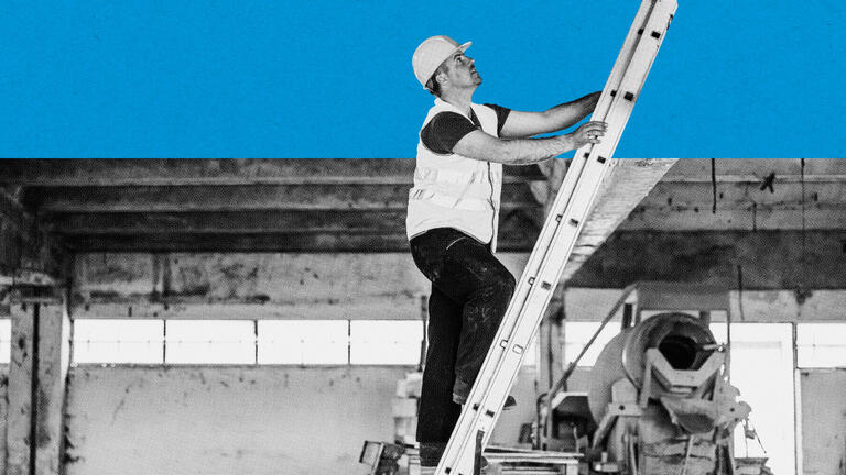A man climbs up a ladder