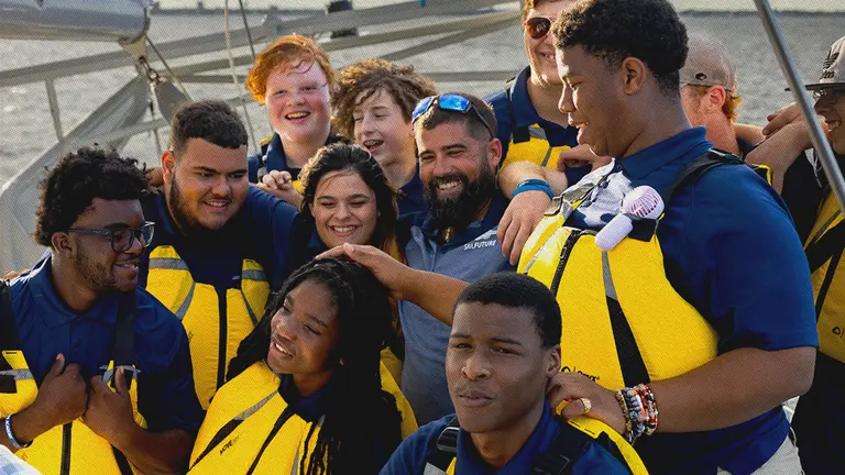 Students on a sailboat at sea