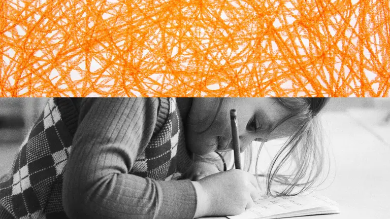 A young student scribbling on a piece of paper