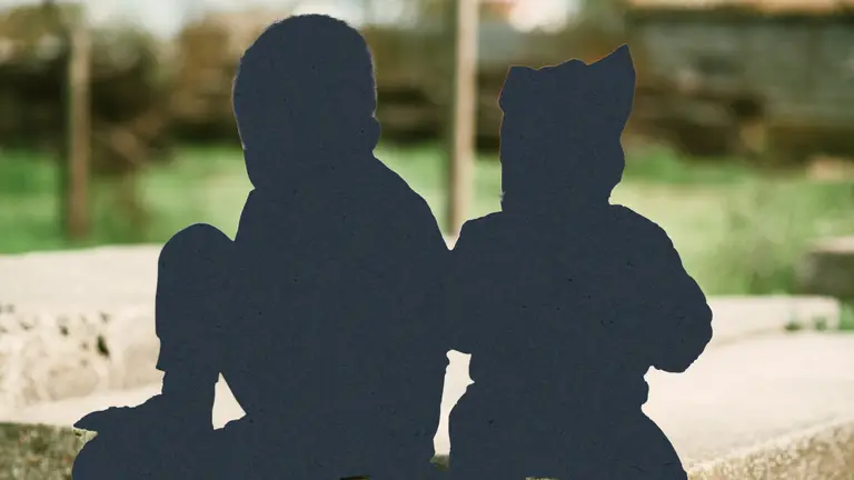 Two silhouettes of kids against a scene outside