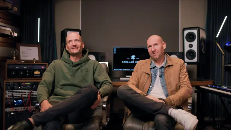 Two men sitting in a music studio.
