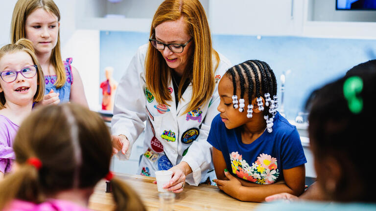 Teacher running an experiment with students.