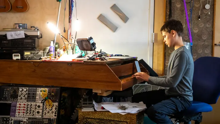 Child playing a piano.