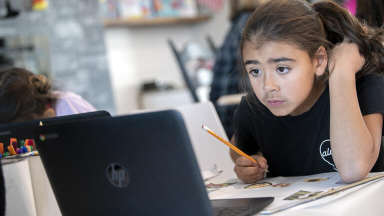 Student doing school work using a laptop