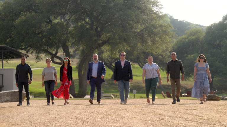 Group walking side by side down a dirt road
