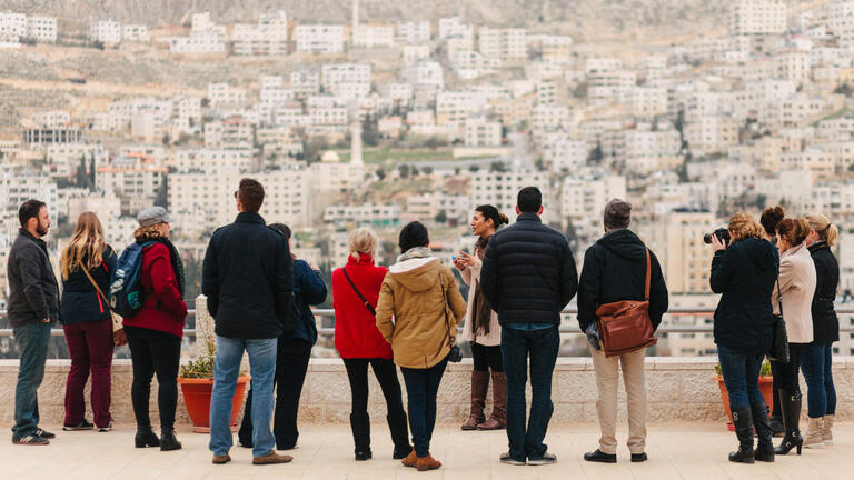 Telos Group members gathered looking over a foreign city