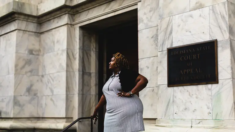 Ursula Newell Davis poses in front of a building