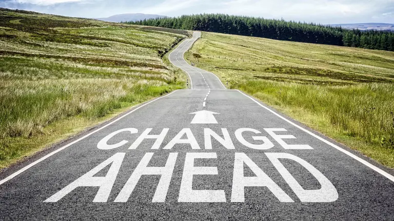 "Change Ahead" painted on a road