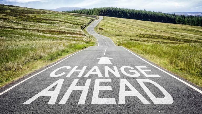 "Change Ahead" painted on a road