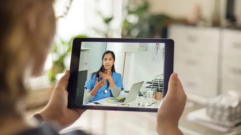 A nurse on a tablet