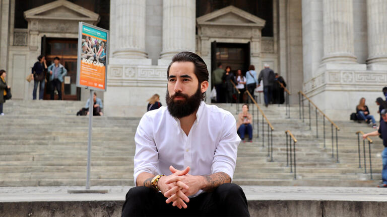 A man sitting on the steps of a building