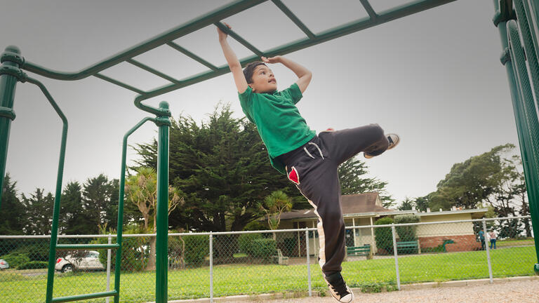 A child playing on monkey bars