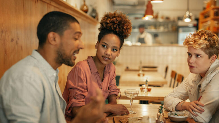 People at a dinner table talking