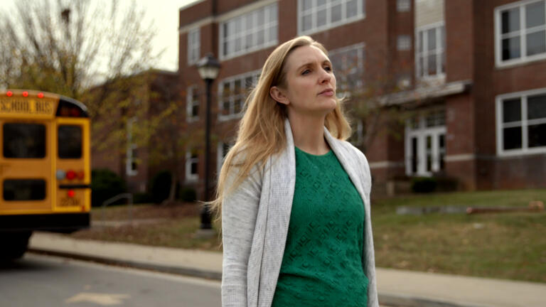 Teacher looks off into the distance longingly