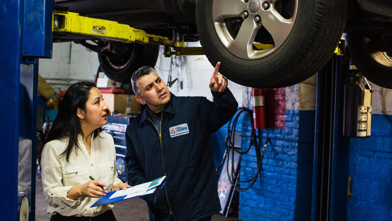 A man and woman in an auto shop