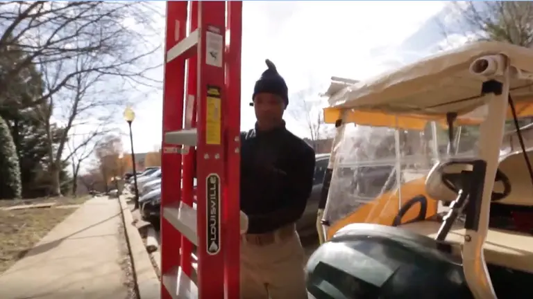 A man carries a ladder