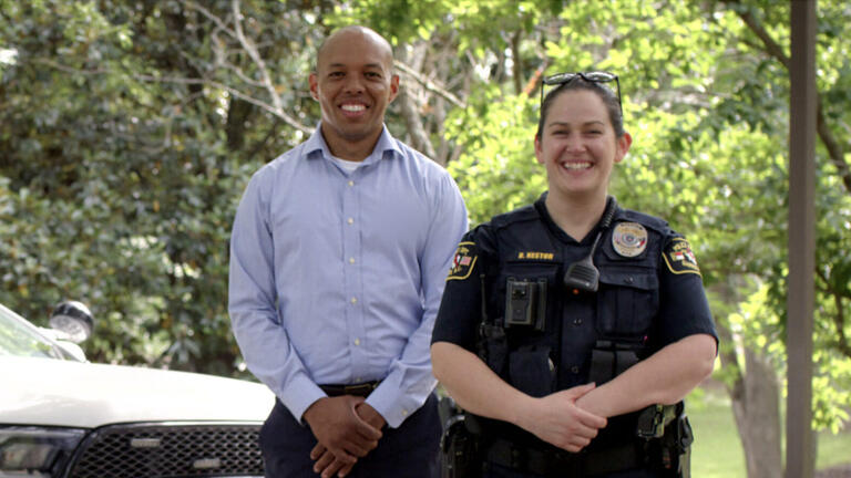Officer and African American man smiling