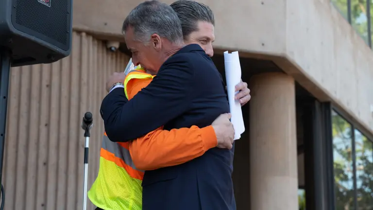 Two men hugging