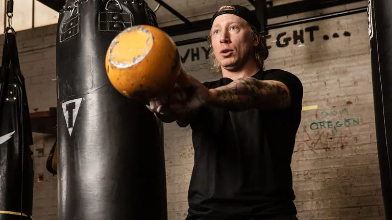 A man exercising with a kettle bell