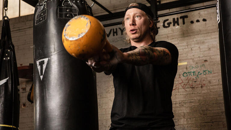 A man exercising with a kettle bell