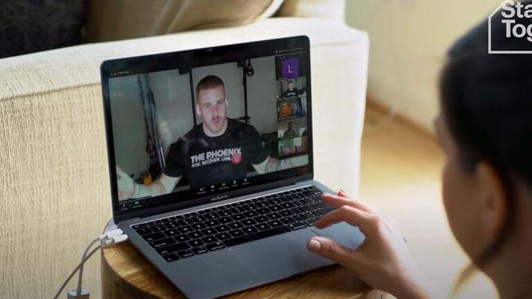 A man speaks on a virtual meeting