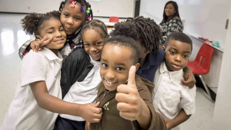 A group of children pose for a photo in school