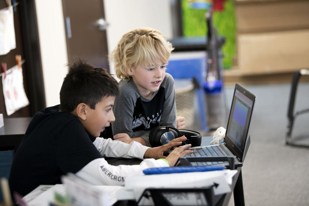 Two students learning with Khan Academy
