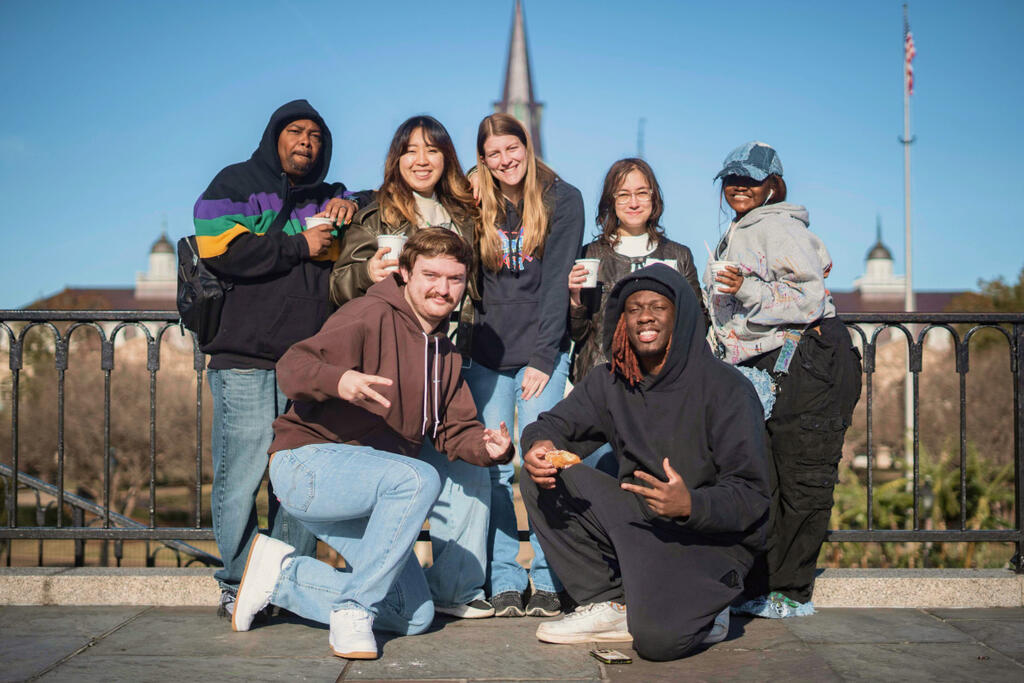 Seven volunteers posing for a group photo on a service trip to New Orleans