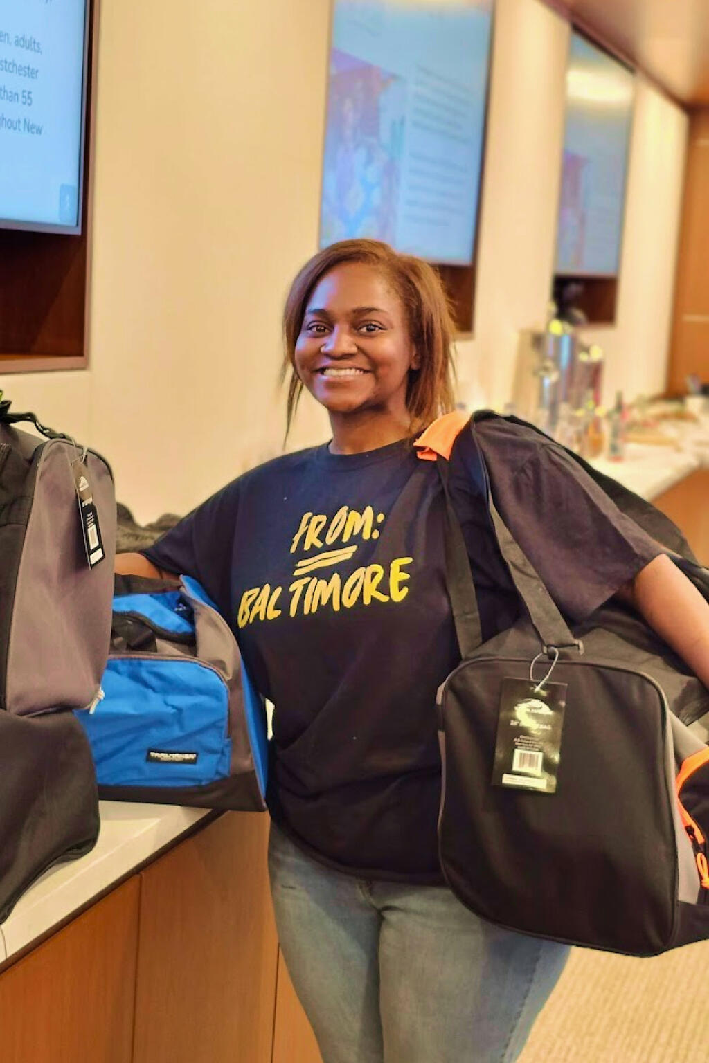 A volunteer with bags that were packed for foster care