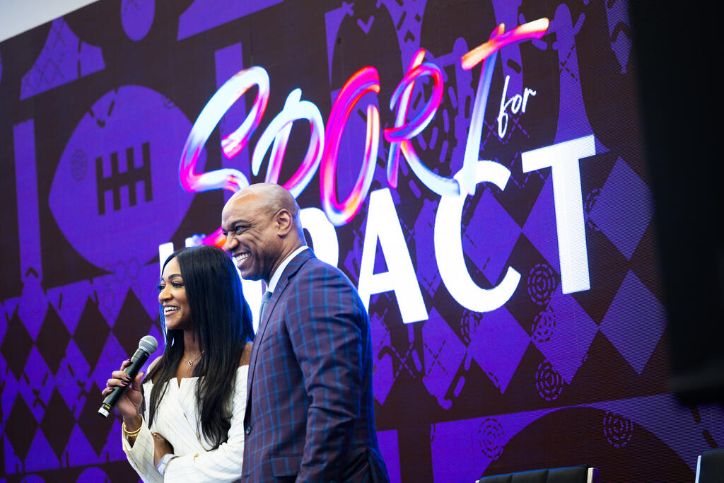 Man and woman standing together on stage.