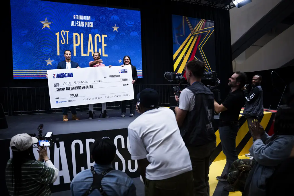 First place winner holding large check.