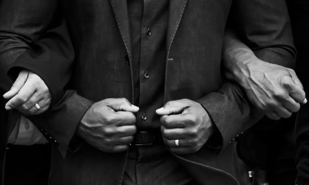 Close up photo of hands and arms locked together.