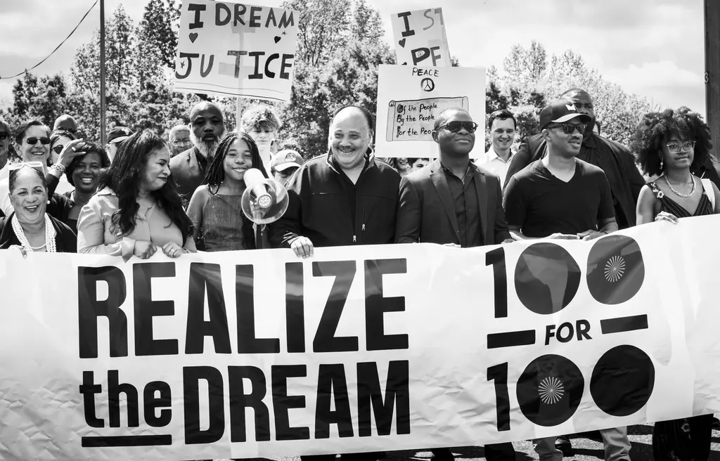 Martin Luther King III and his family hold onto the Realize the Dream banner.