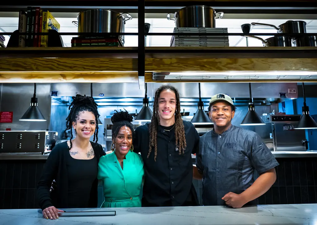 Group smiling in the kitchen.