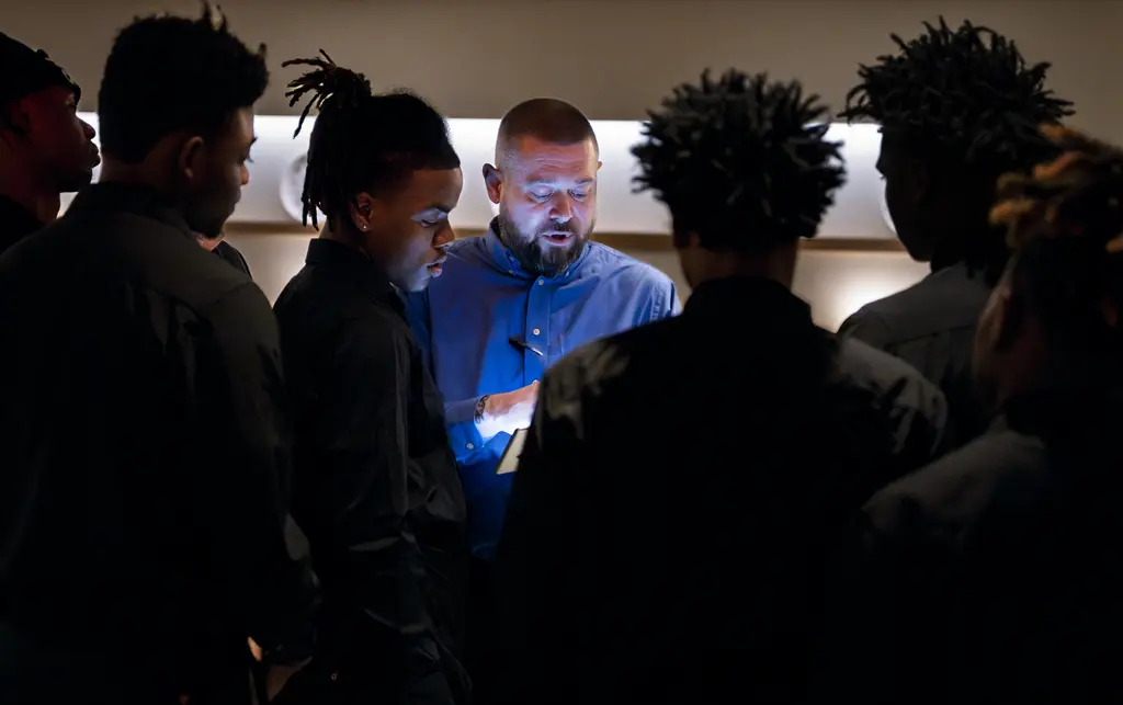 General manager and interns prepare during shift meeting.