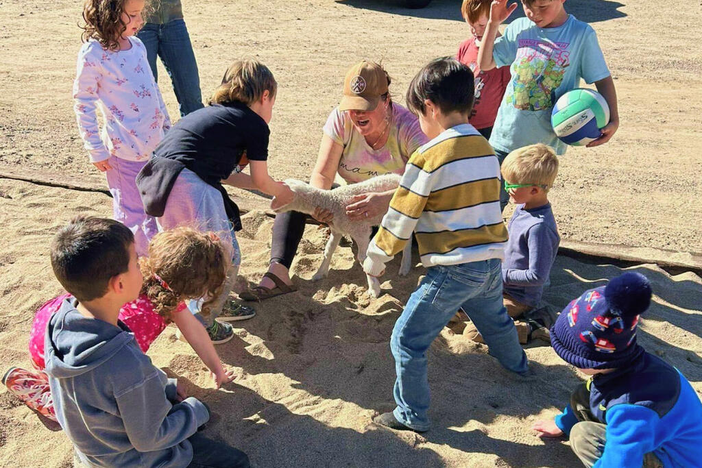 Children petting an animal.