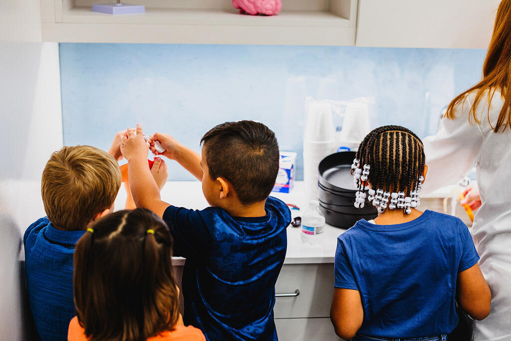 Children participating in science lab.