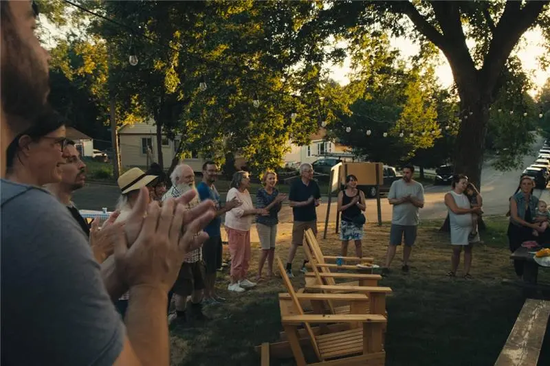 Jr. and his partner, Chrissy, are surrounded by neighbors