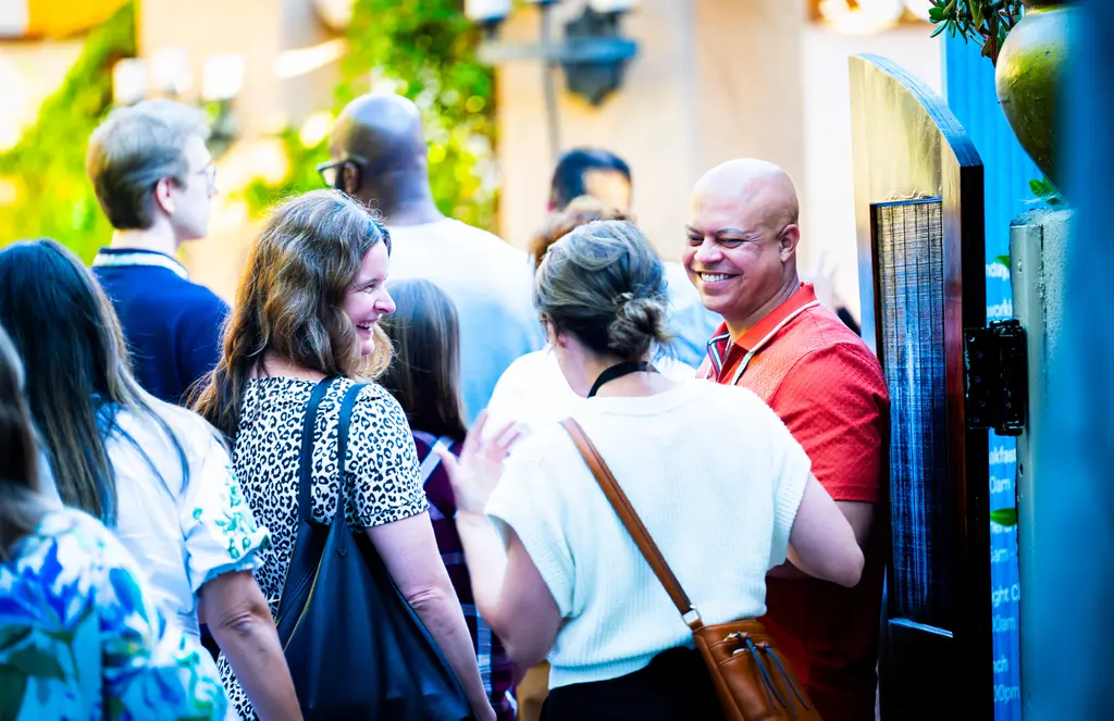 Jon-Adrian “JJ” Velazquez, the Frederick Douglass Project for Justice’s program director, speaks with other attendees at Stand Together Foundation’s Changemakers Summit in August 2025.