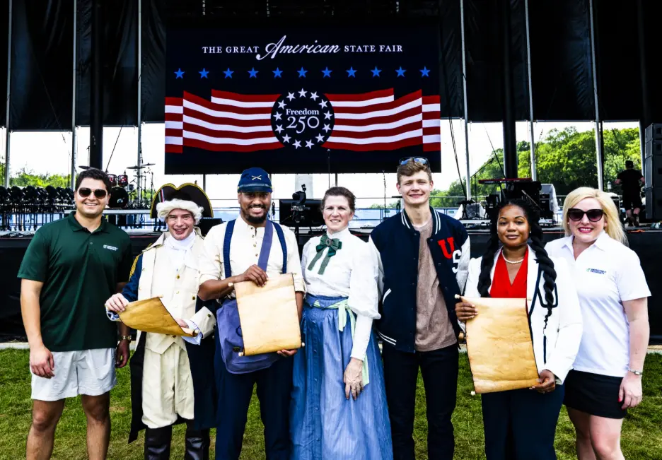 Americans for Prosperity employees pose for a group photo at the organization's exhibit at the Great American State Fair.